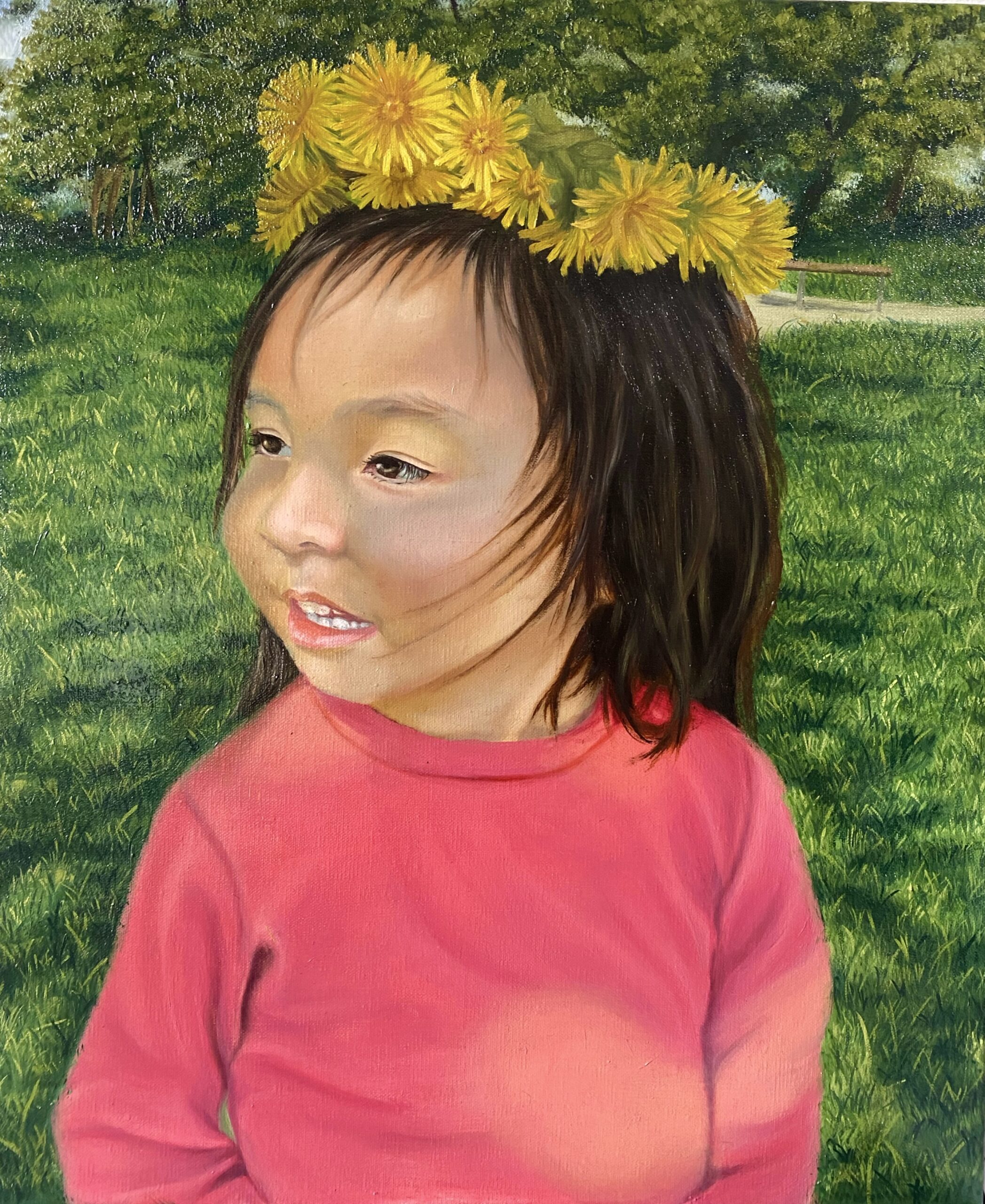 An oil on canvas portrait painting of a small child. The child is wearing a dandelion flower crown with a pink hoodie, sitting against a background of green grass and bushes. The child is depicted with soft and realistic smiling features.